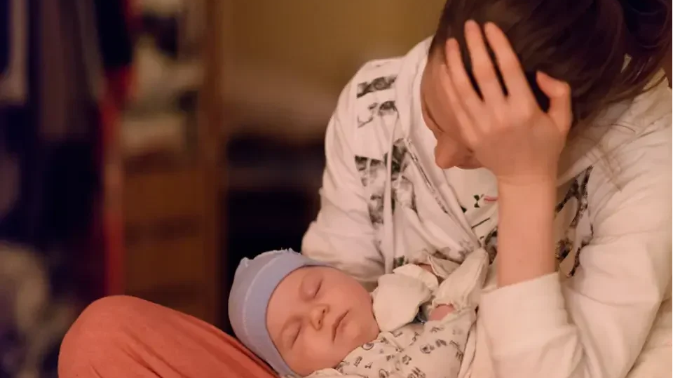 A mother with postpartum depression feels sad