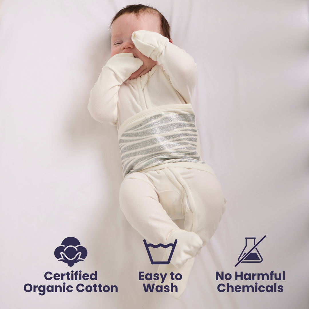 Baby wrapped in organic cotton Convertible PJs with certification icons and text.