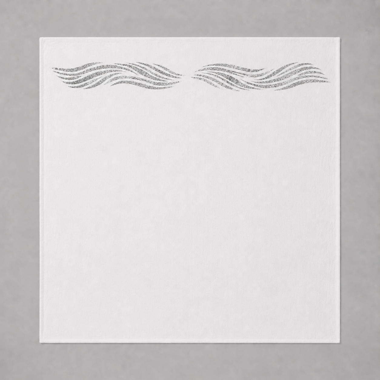 White swaddle blanket with silver sparkly reflective waves on a gray background