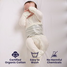 Baby wrapped in organic cotton Convertible PJs with certification icons and text.