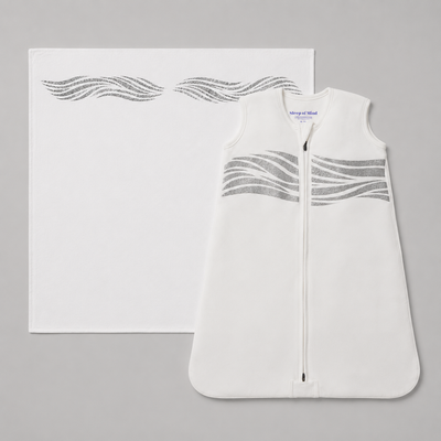 The Early Stages Bundle | 0 - 7 months includes a white baby sleep sack and a matching blanket, both adorned with gray wavy lines. Ideal for cozy sleepwear, the sleep sack features a convenient front zipper for easy changes. The background is a solid light gray.