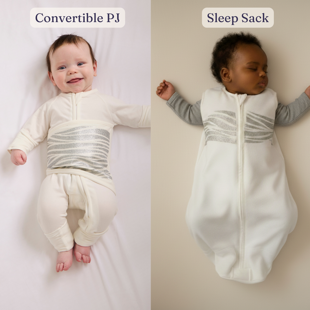 Two babies in light-colored outfits rest on a soft surface. The baby on the left wears the separated-leg style from the First 6 Months Bundle | 0 - 6m, while the baby on the right is cozy in a sleep sack with enclosed legs from the same bundle. Both sets of baby breathing sleepwear feature silver horizontal stripes on the front.