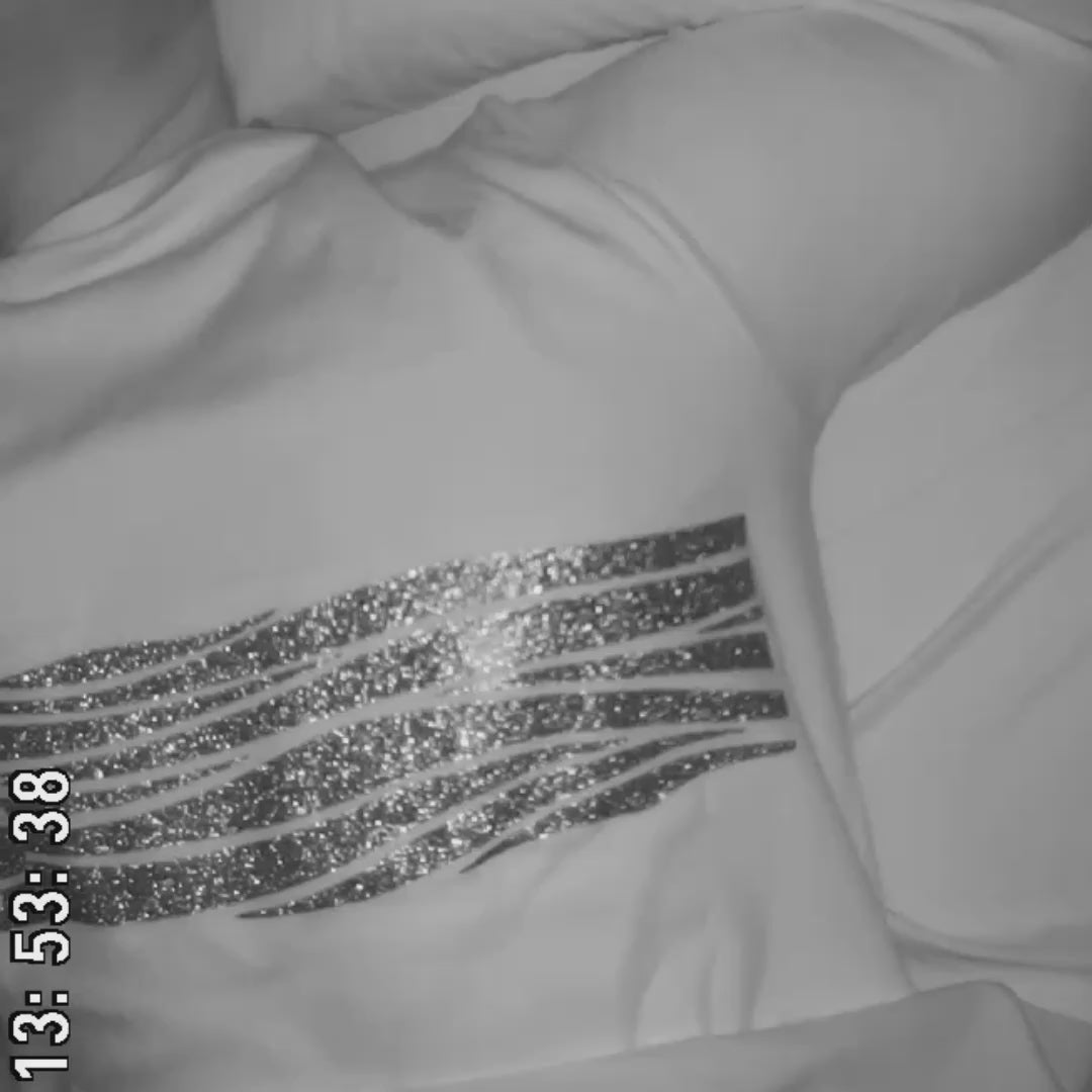 Man sleeping with Sleep of Mind adult pajama top and the design on the PJ top is shimmering with each breath he takes